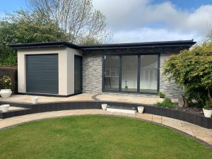 Dark grey bifold doors leading out to the lawn